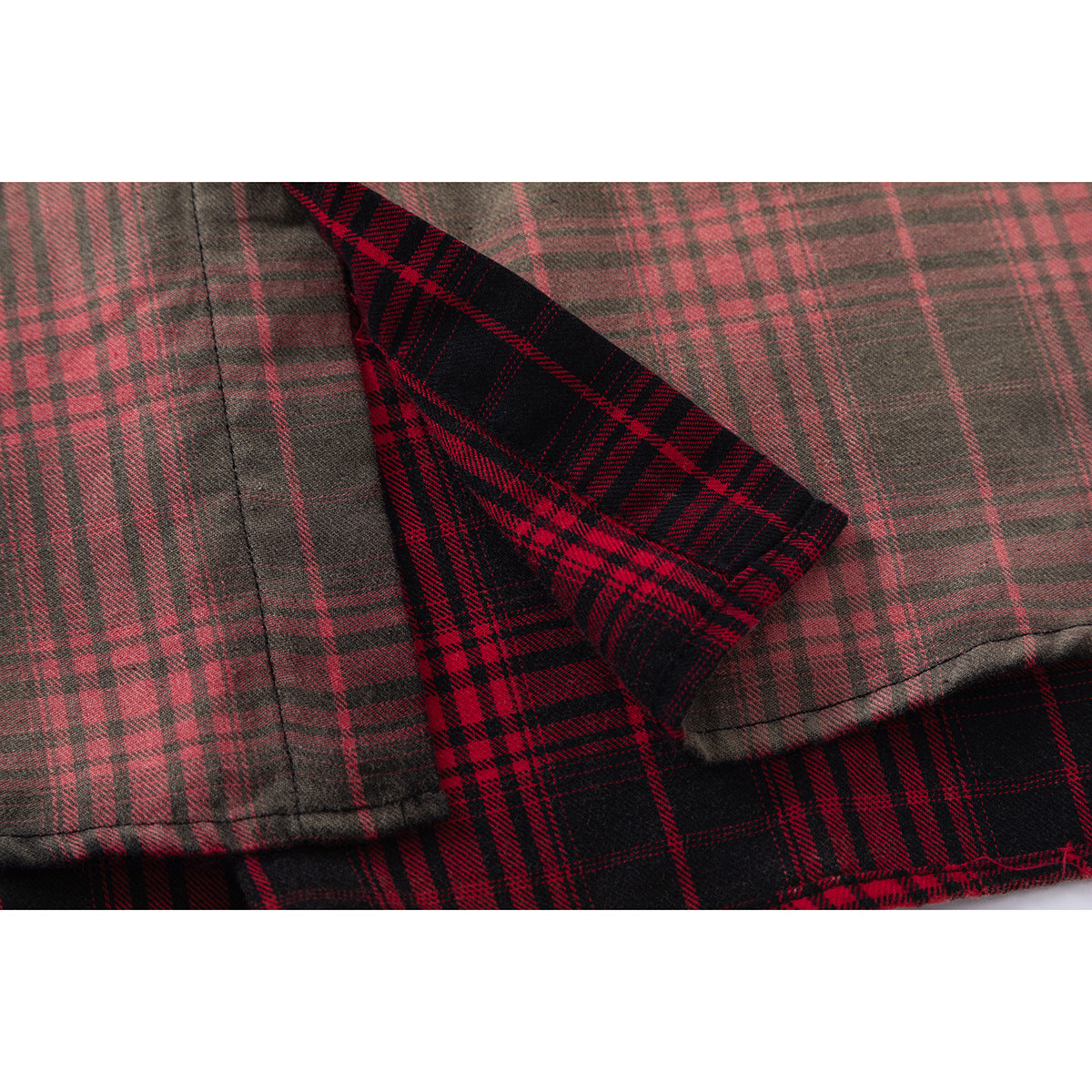 Close-up showing the red-and-black plaid shirt fabric folded back to reveal its lighter reverse side.