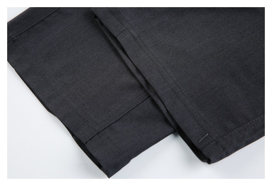 Close-up of charcoal trouser legs showing the hems and seams laid flat.