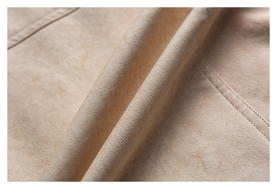 Close-up of beige garment fabric gathered into a raised fold, with stitching visible nearby.