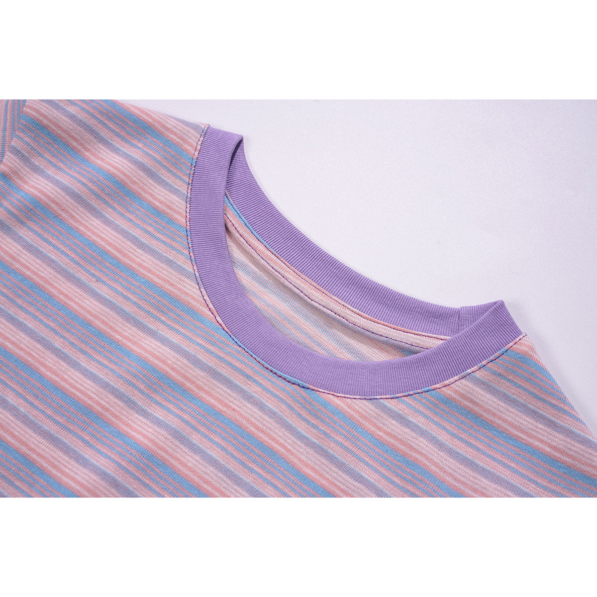 Close-up of a pink-and-blue striped long-sleeve shirt with a wide purple crew neckline.