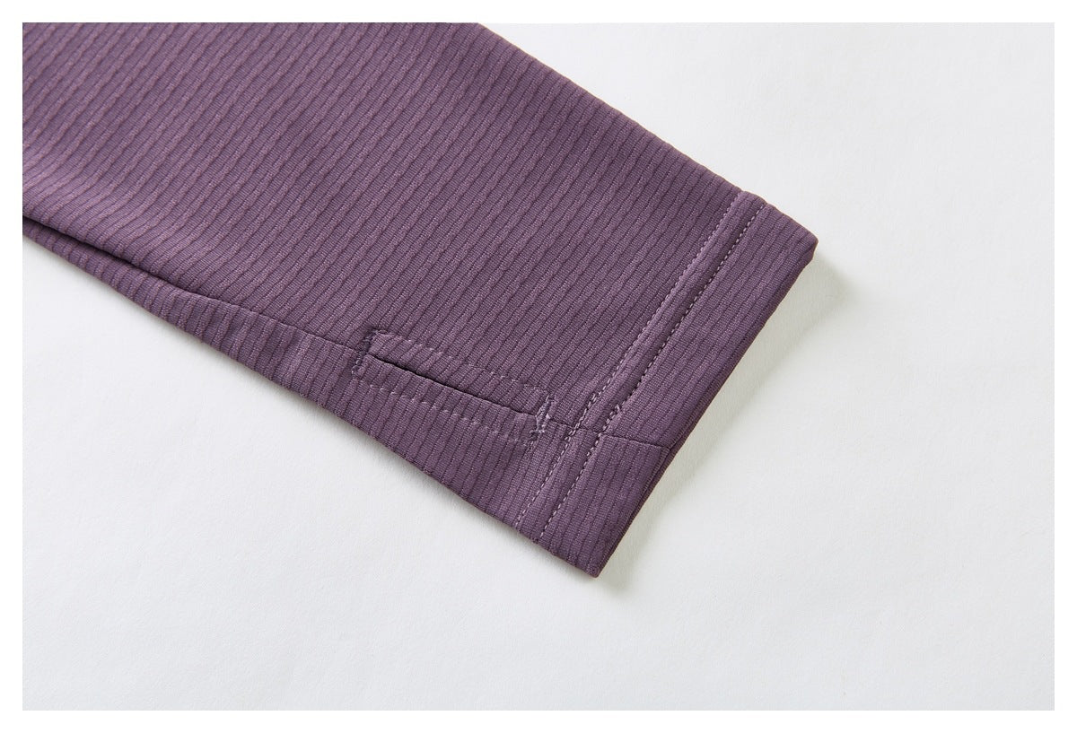 Purple ribbed jacket sleeve cuff with a small stitched tab and seam detail.