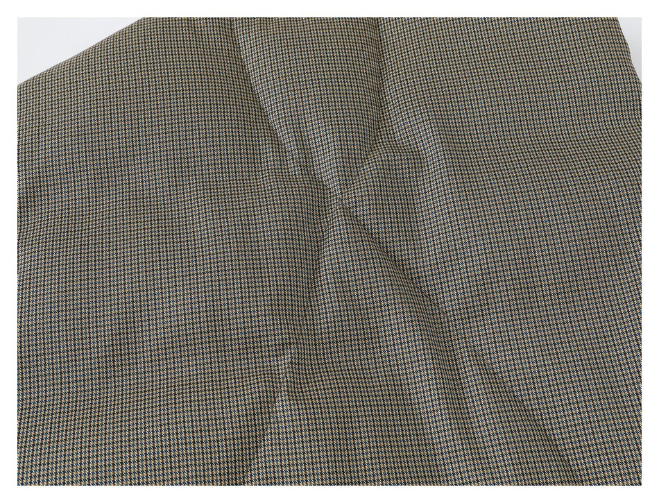 Close-up of a broad panel in tan, navy, and cream patterned fabric.