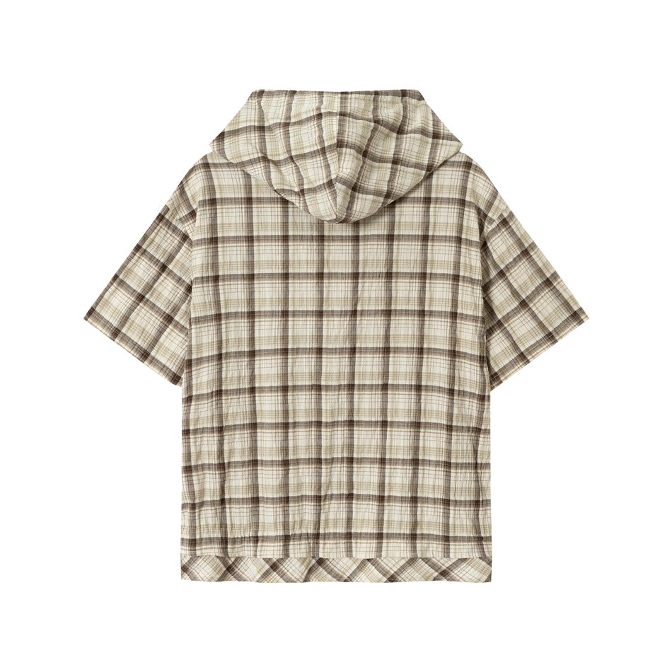 Back view of beige and brown plaid short-sleeve hooded shirt, flat lay with hood and crinkled fabric texture