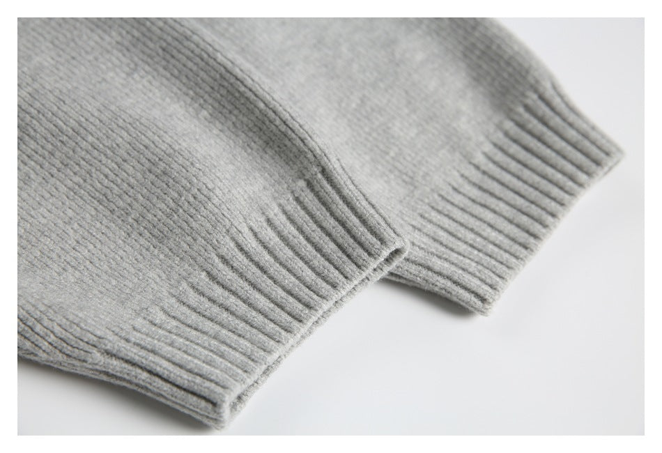 Close-up of ribbed cuffs on a light gray knit garment.