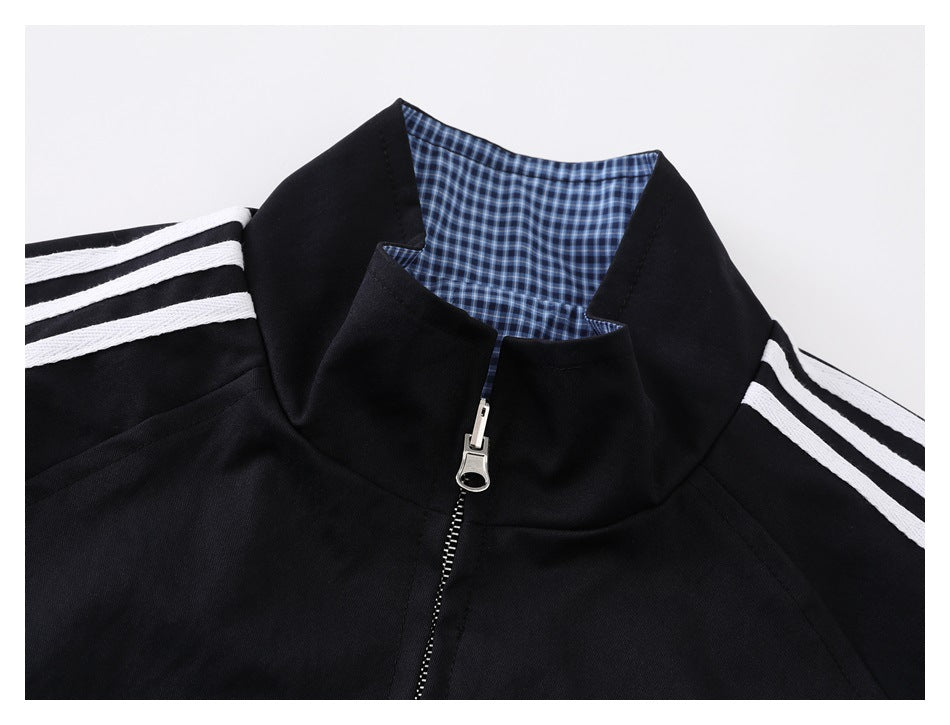 Close-up of the black jacket collar, checked inner lining, and front zipper.