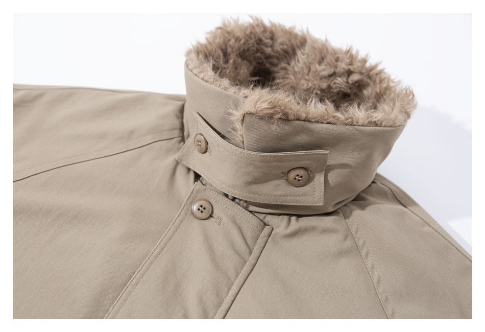 Close-up of a beige coat collar with plush lining, buttoned throat tab, and front buttons.