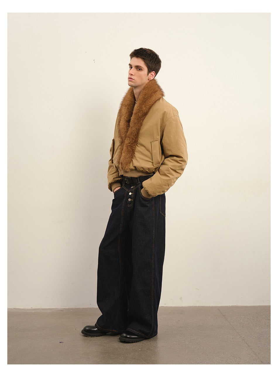 Model wearing a tan bomber jacket with a plush brown collar, ribbed cuffs and hem, and dark wide-leg jeans.
