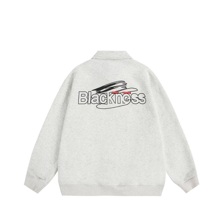 Back view of a light heather gray pullover sweatshirt with ribbed cuffs and hem and a black, white, and red graphic.