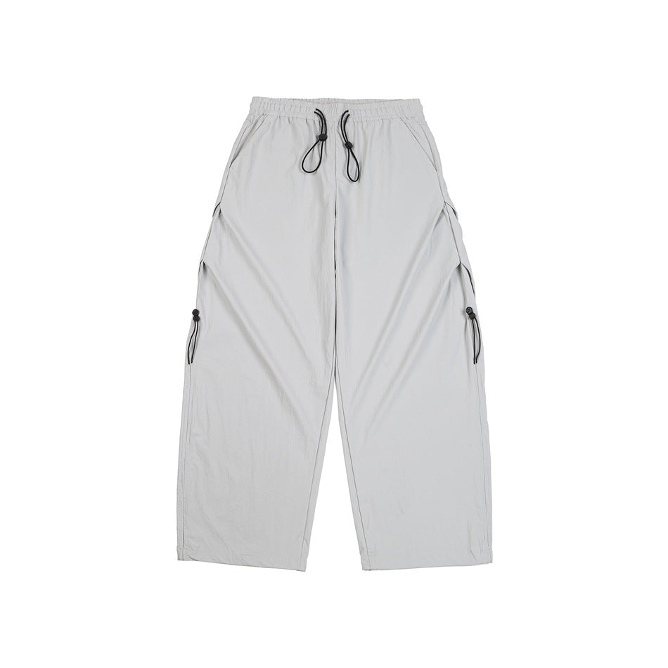 Front view of light gray wide-leg trousers with an elastic drawstring waist and side details.