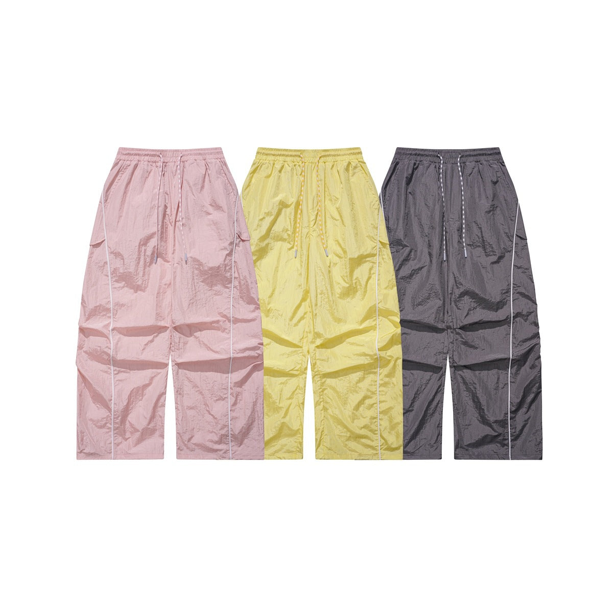 Three pairs of wide-leg drawstring pants shown together in pink, yellow, and charcoal gray.