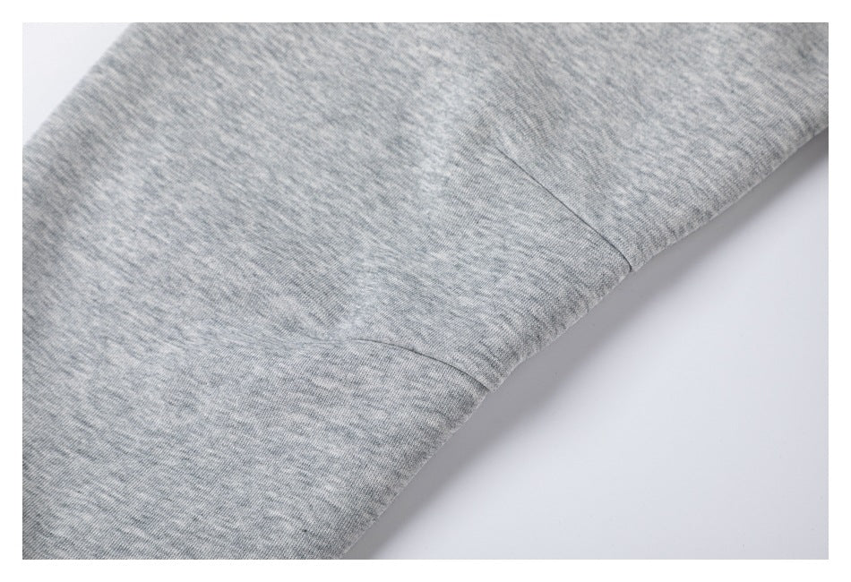 Close-up of a stitched seam joining sections of heather-gray fabric.