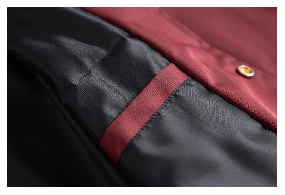 Close-up of the jacket’s dark lining with a burgundy seam detail and a snap fastener.