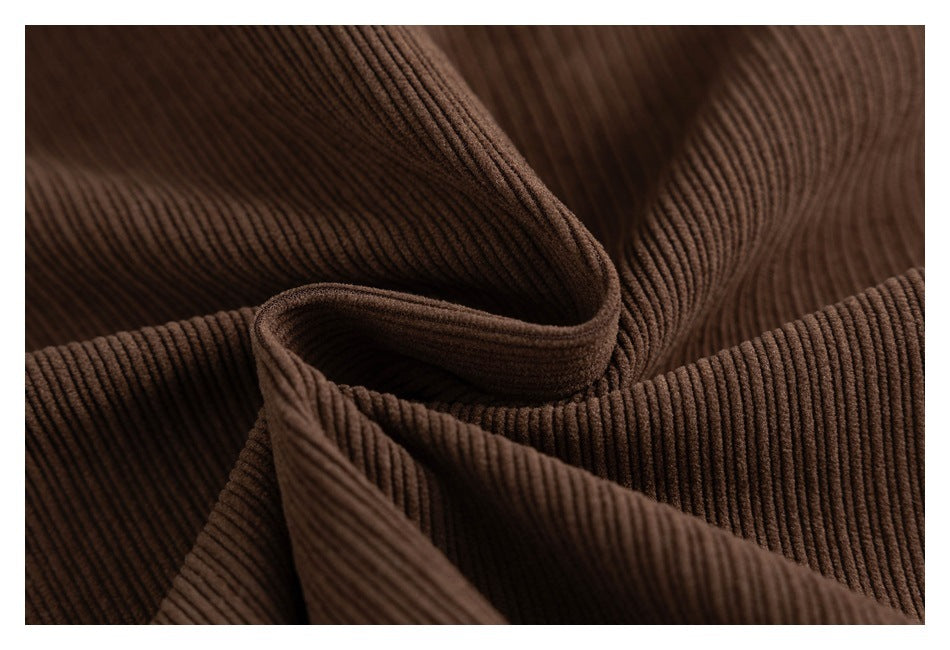 Close-up of brown ribbed fabric arranged in soft folds.
