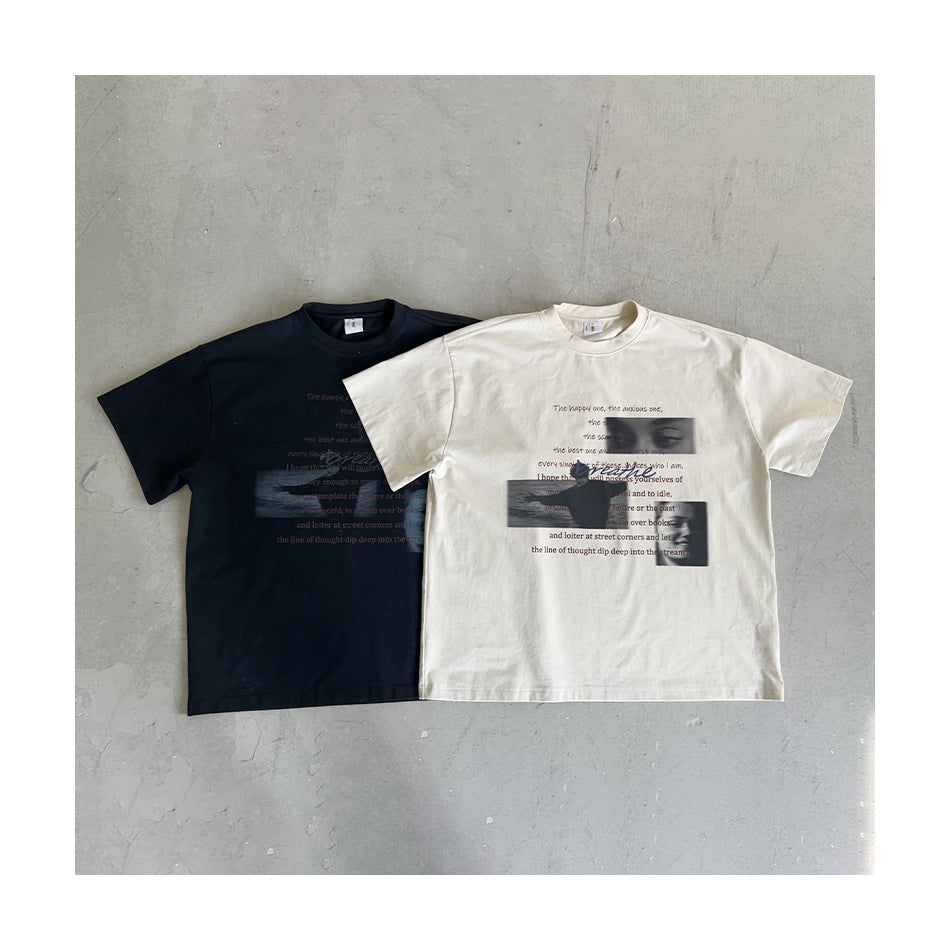 Black and light khaki graphic T-shirts laid flat side by side on a gray concrete surface