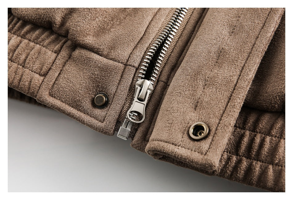 Close-up of a brown jacket showing a metal zipper, snap buttons, and stitched placket.