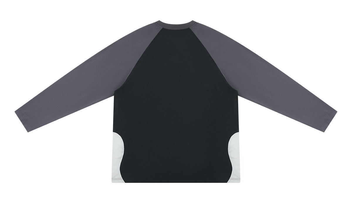 Flat-lay back of a black long-sleeve shirt with charcoal raglan sleeves and white lower side panels.