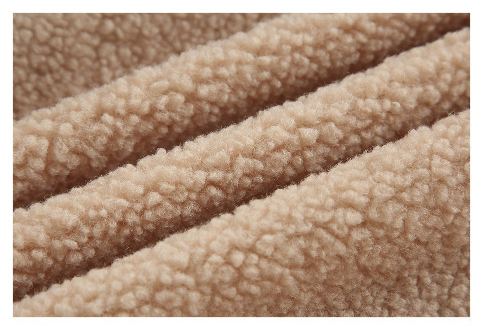 Macro view of cream curly plush fabric arranged in folds.