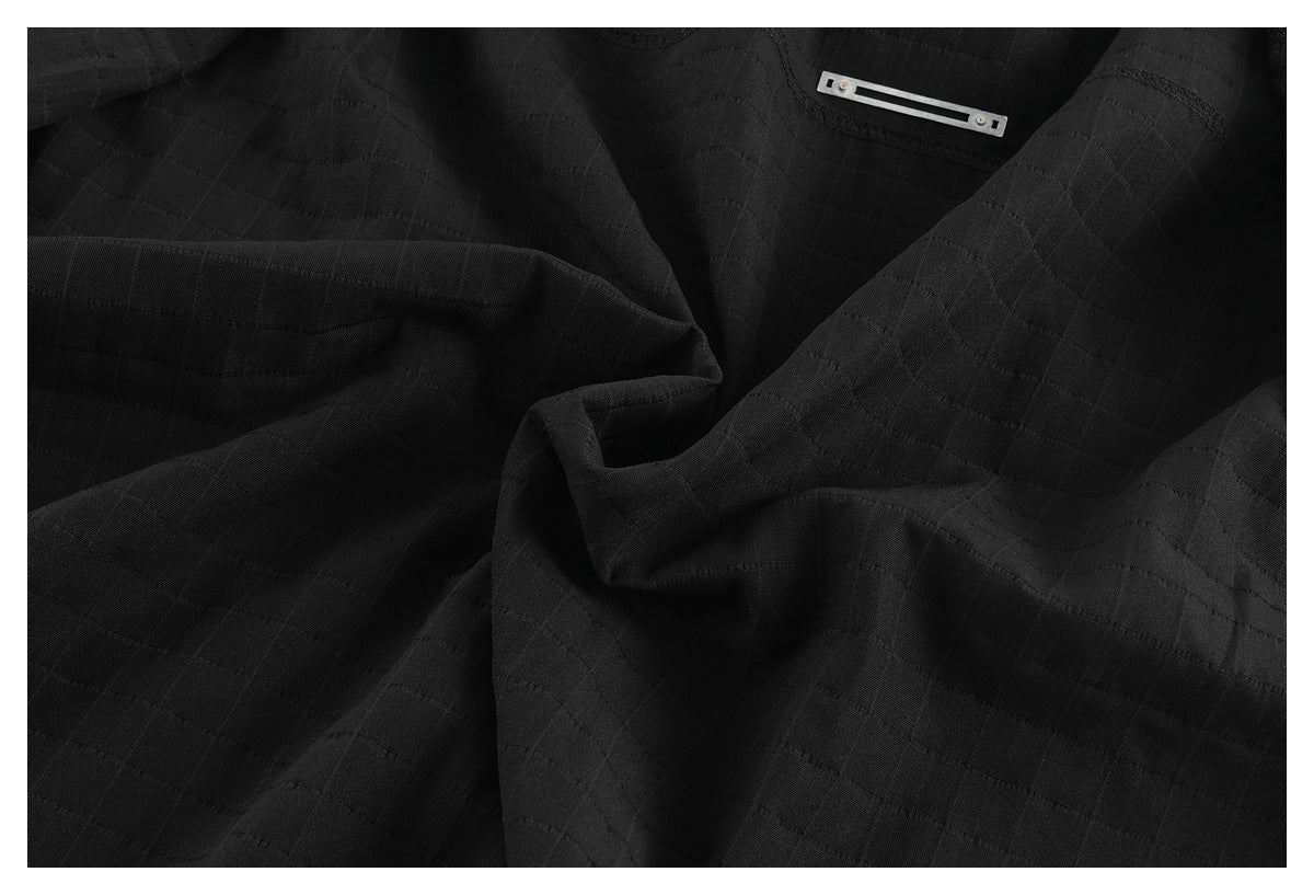 Close-up of the black shirt fabric's subtle grid texture and an interior metal detail.