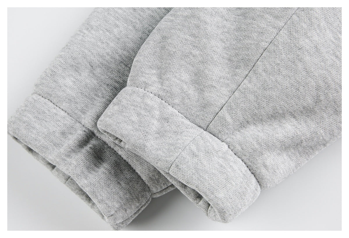Close-up of heather gray knit garment fabric with folded, stitched cuff edges.