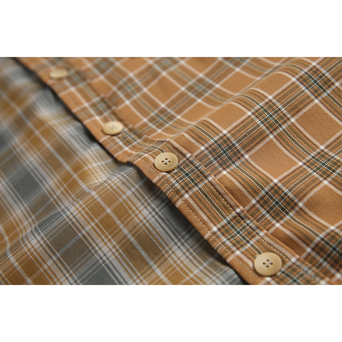 Close-up of the shirt's brown and gray plaid fabric, front buttons and seam stitching.
