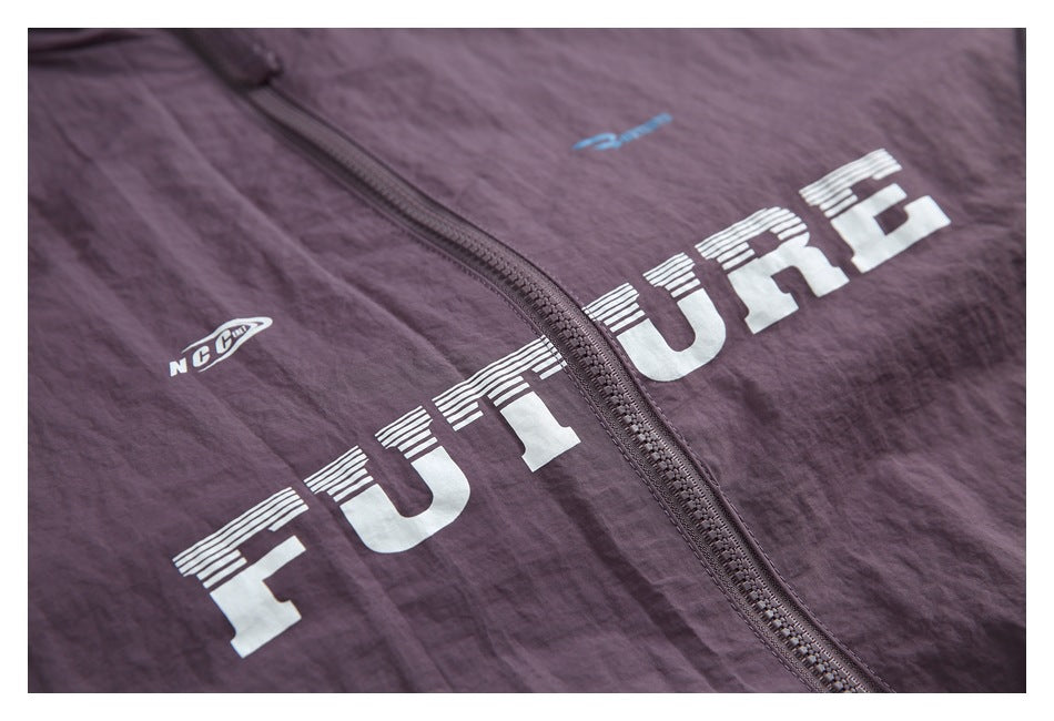 Close-up of a plum zip-front garment with large white lettering and small logo prints.