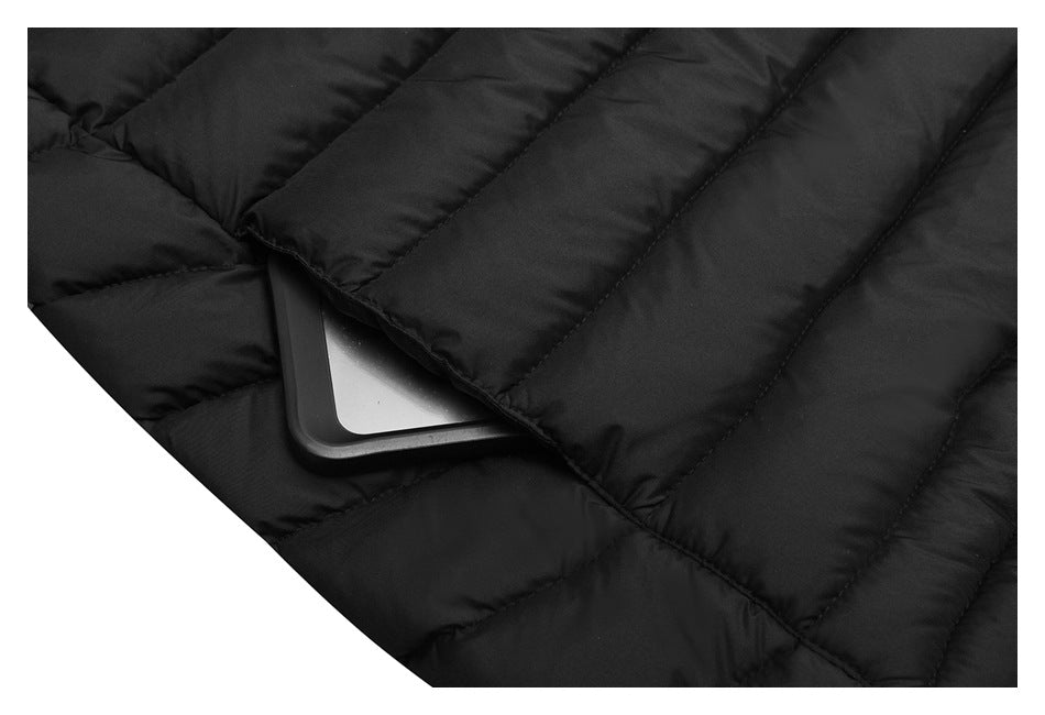Close-up of the black quilted jacket's pocket area with a rectangular object beneath the flap.