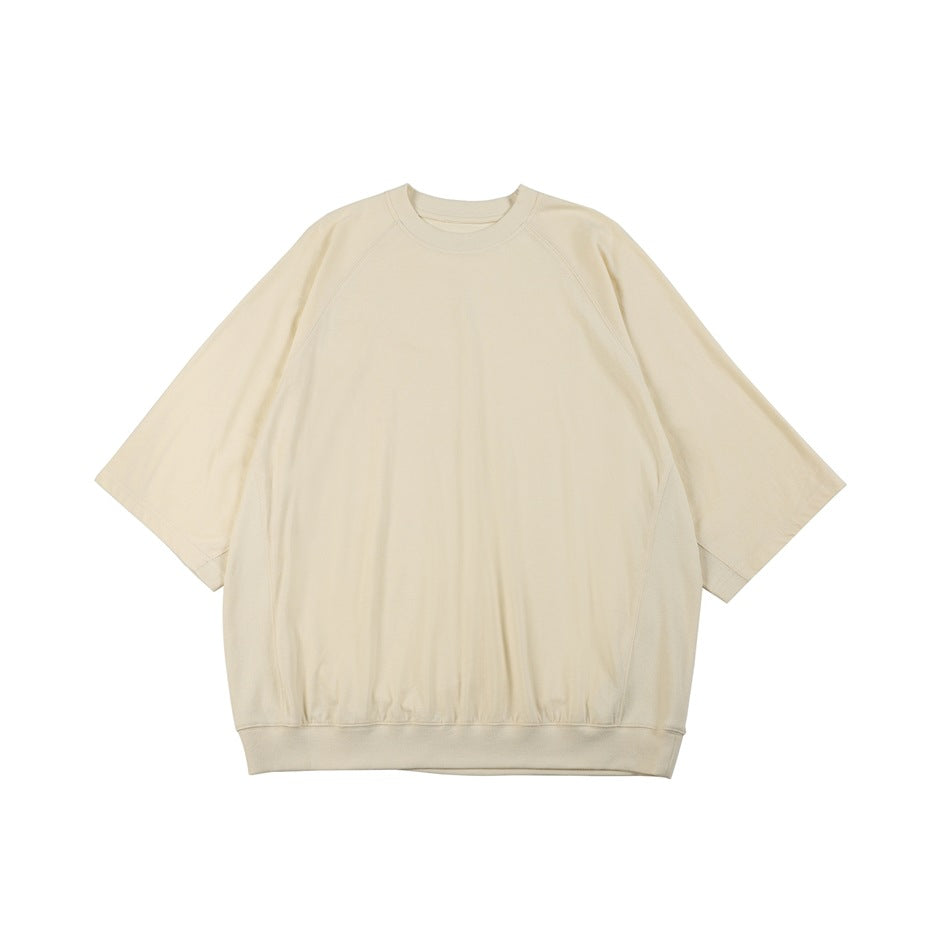 Apricot oversized crew-neck raglan tee with ribbed hem, flat lay front view