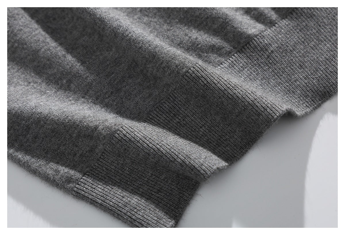 Gray knit sweater fabric and thick ribbed hem shown in close-up.