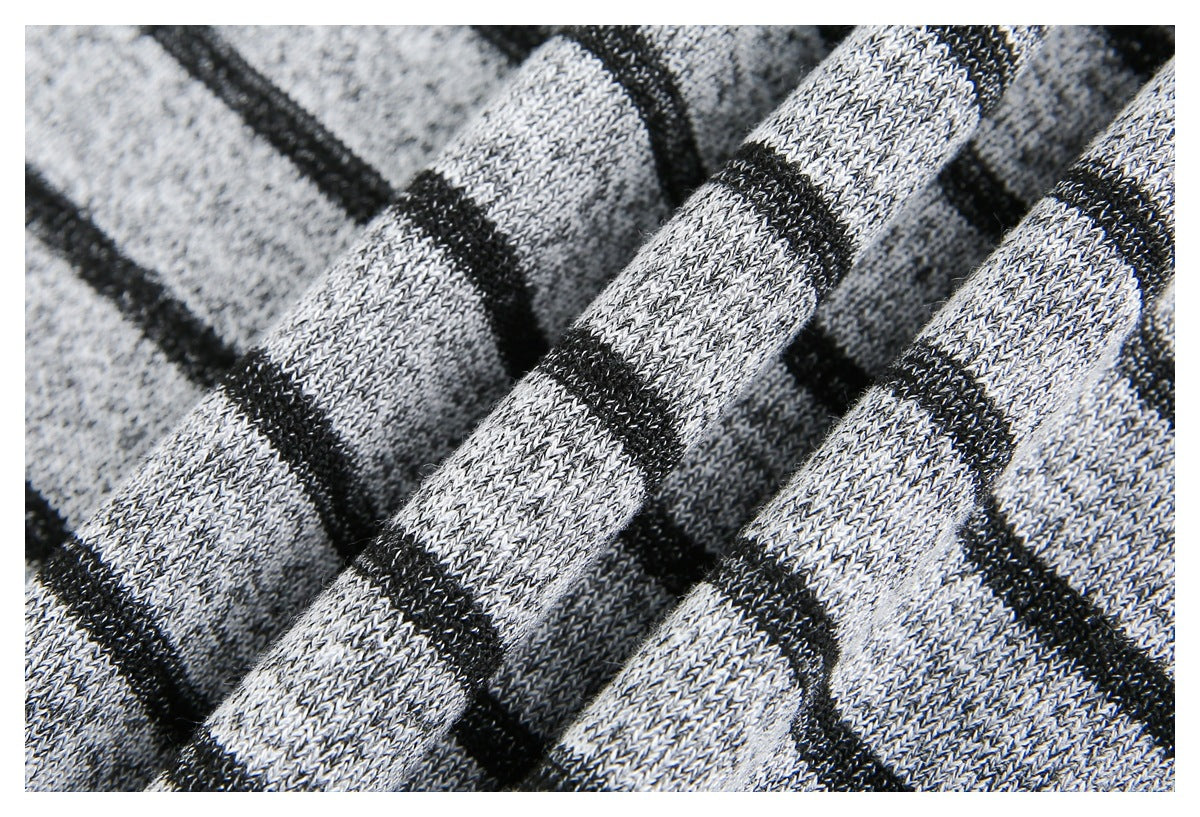 Macro view of folded gray knit fabric with narrow black stripes and visible stitch texture.