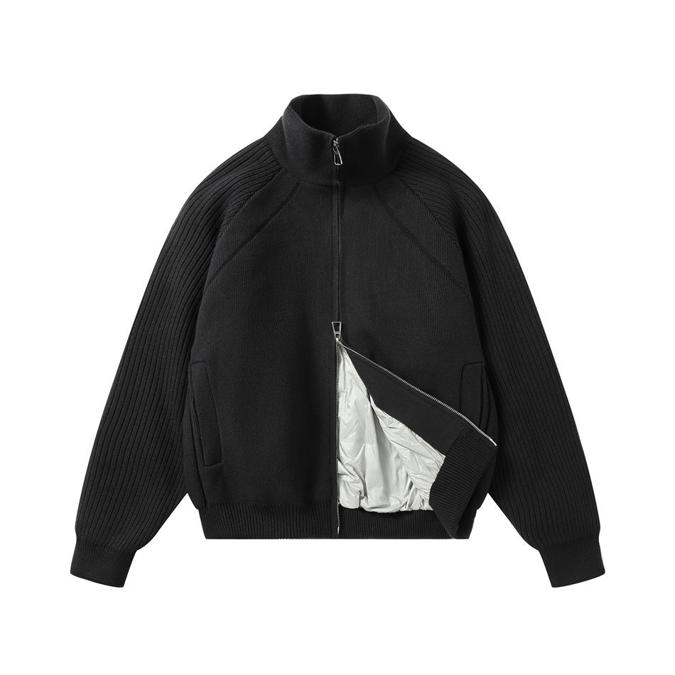 Black zip-front knit jacket partly unzipped to reveal a light-colored inner lining.