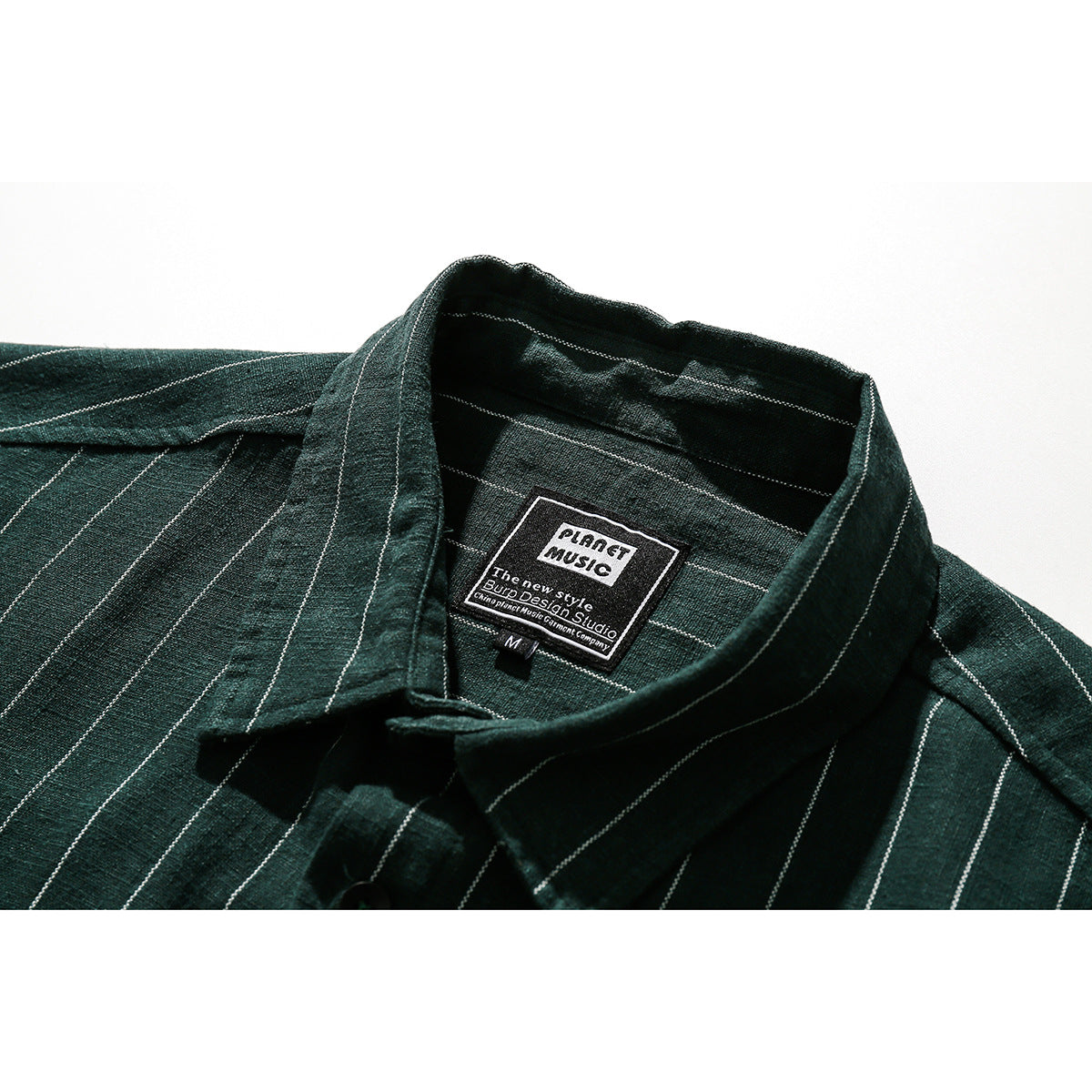 Close-up of a dark green pinstriped shirt collar and inner neck label.