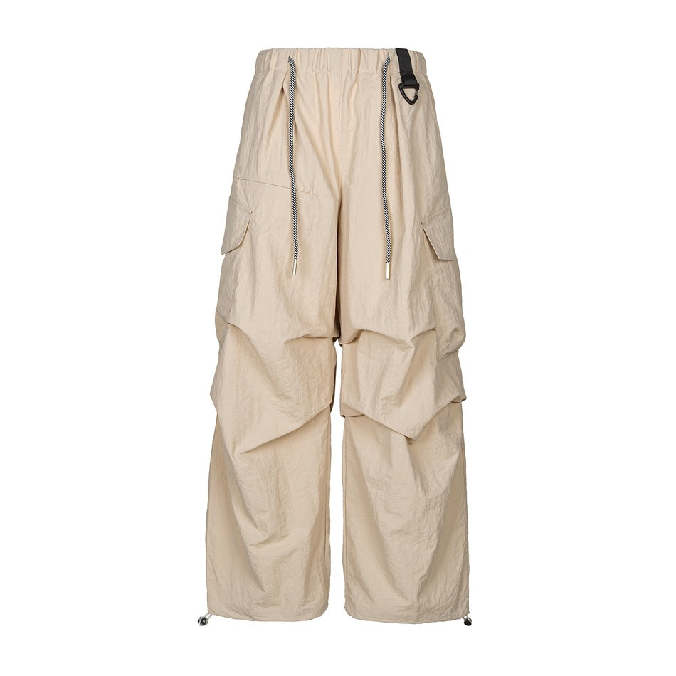 Khaki wide-leg cargo pants with elastic waist, striped drawcord, side flap pockets and knee pleats, front view