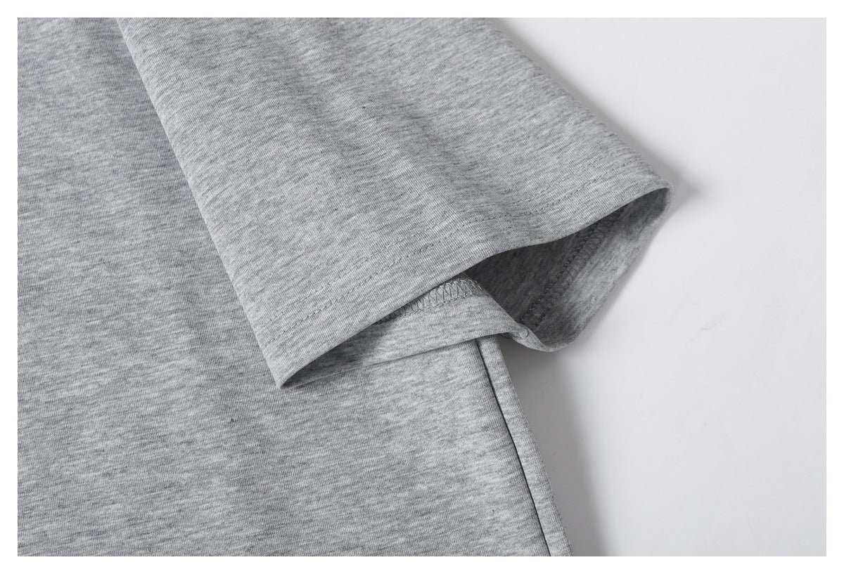 Close-up of the gray short sleeve and its stitched hem.