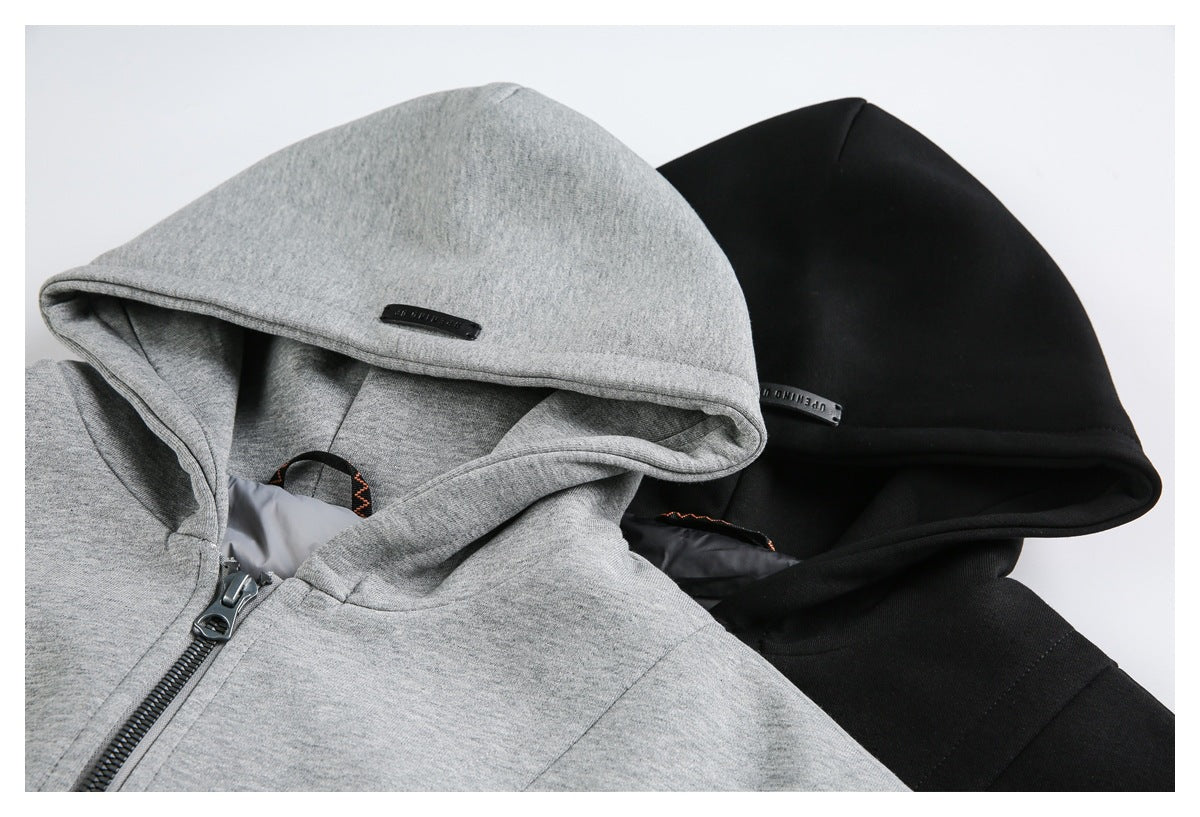 Close-up of gray and black hooded sweatshirts, showing the hoods and front zipper area.