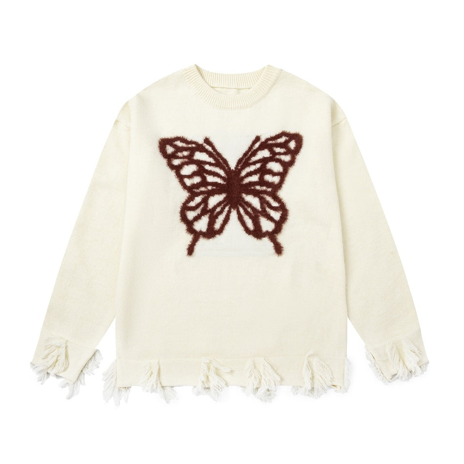 Cream knit sweater with brown fuzzy butterfly motif and frayed fringe hem and cuffs, flat lay front view