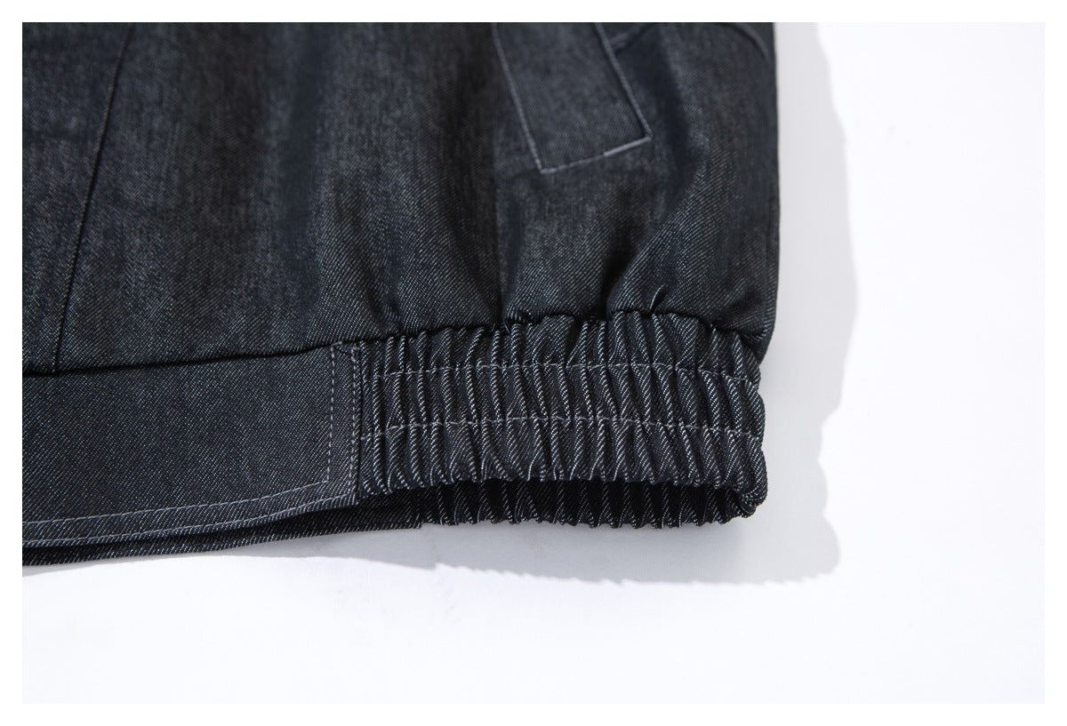 Close-up of a gathered elastic waistband on dark indigo fabric.