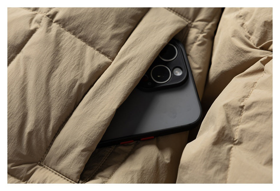A smartphone is partly tucked into a pocket in the beige quilted jacket.