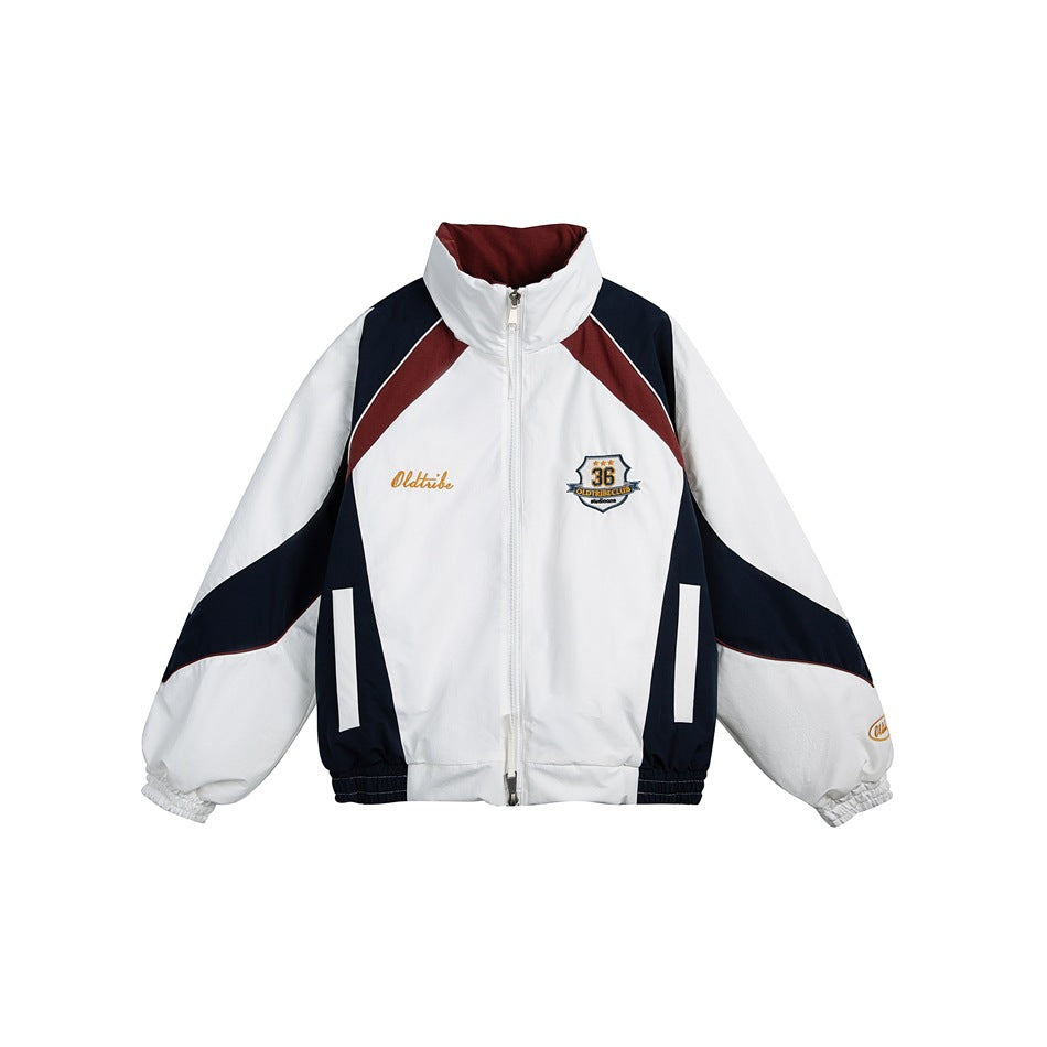 White zip-up stand-collar jacket with navy and burgundy color-block panels and embroidered chest badge