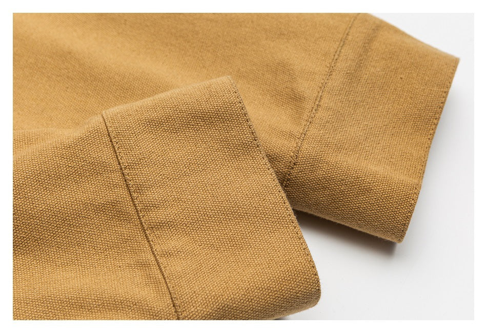 Close-up of a tan jacket sleeve cuff and stitched seams.