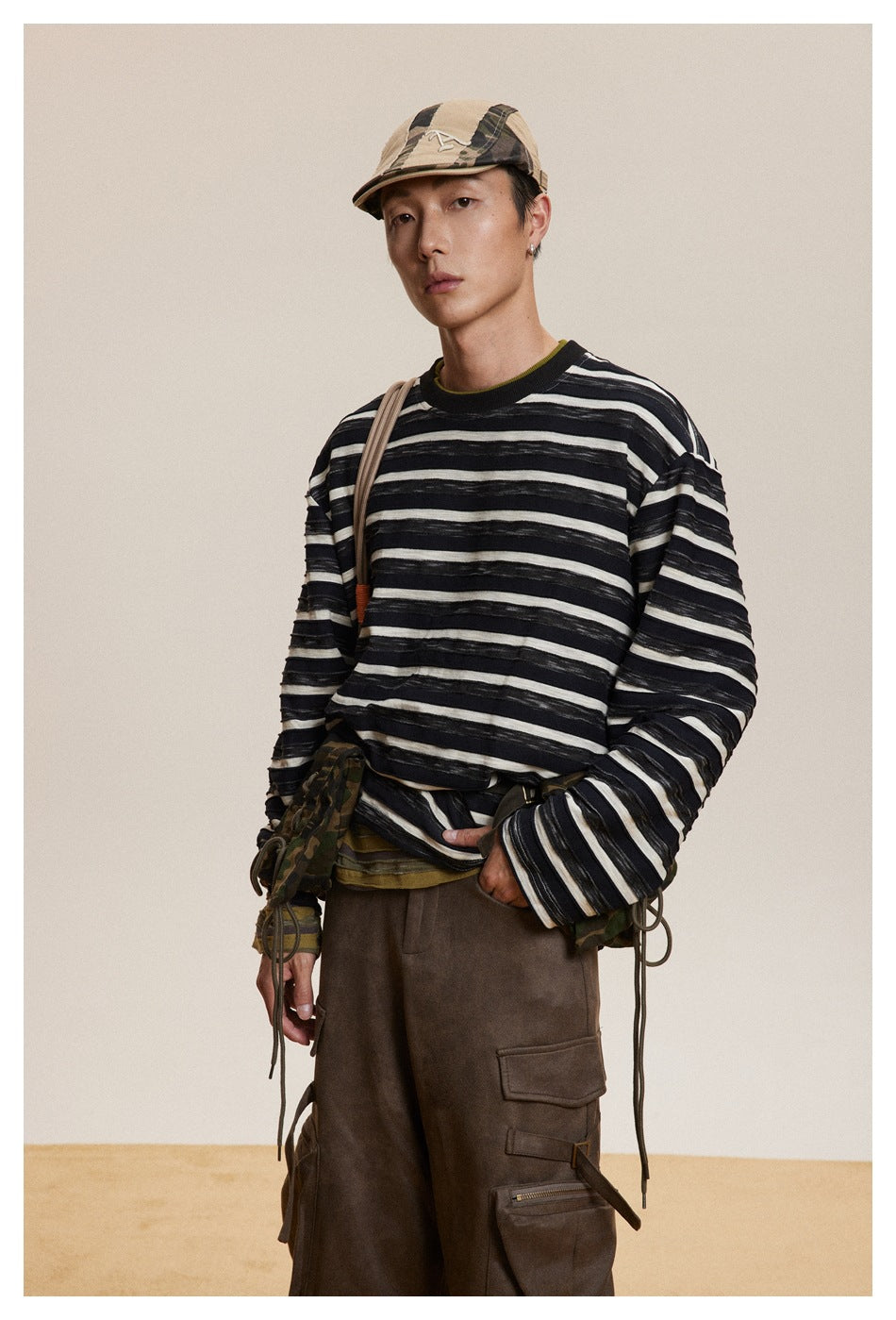 Model in a black-and-cream striped long-sleeve shirt, shown from the front at a slight angle.