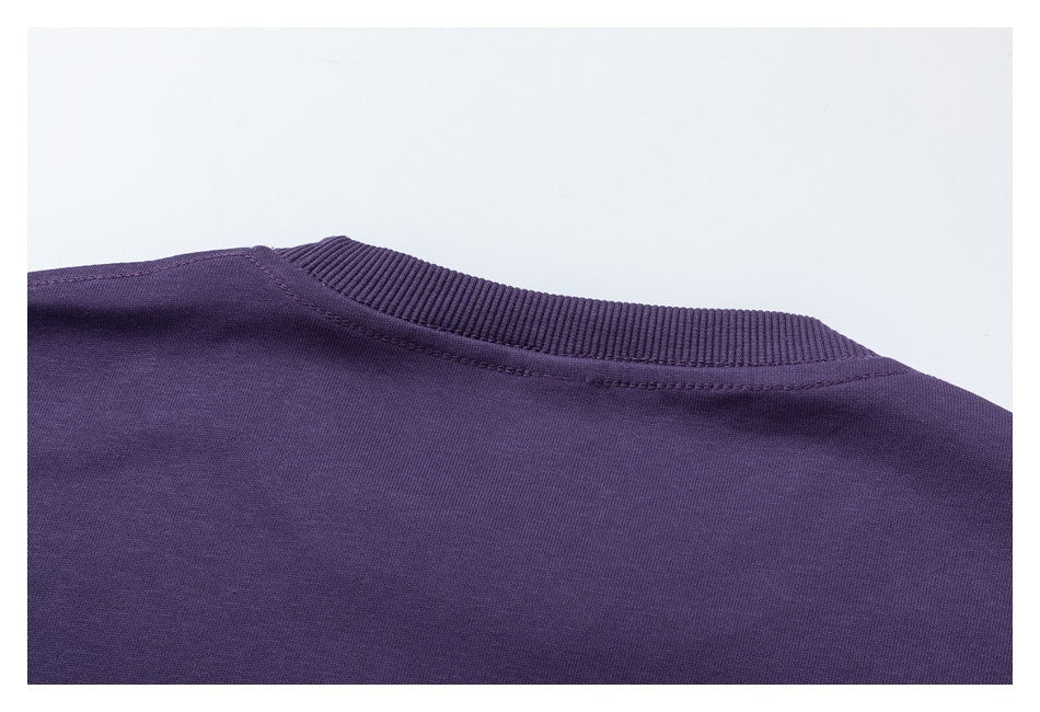 Close-up of the purple sweatshirt's ribbed crew neckline and back shoulder seam.