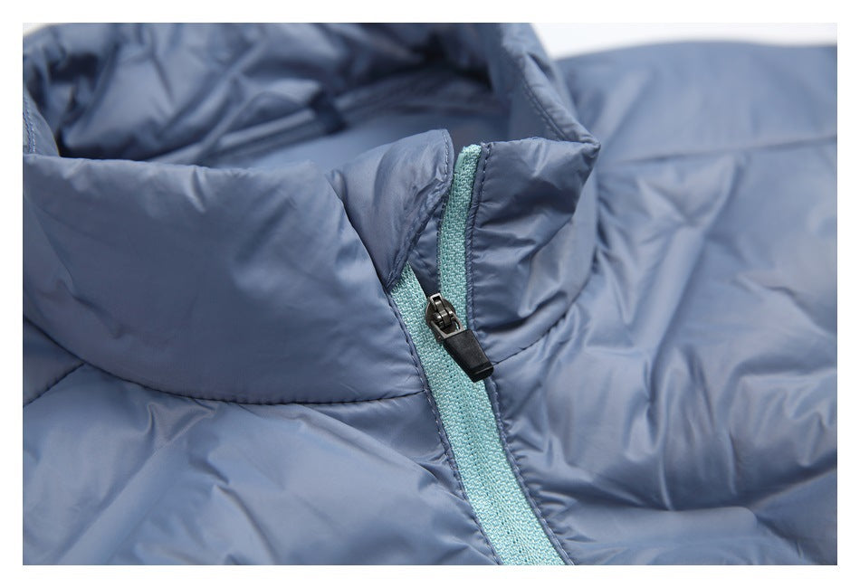 Close-up of the blue-gray jacket collar and turquoise zipper tape with a black zipper pull.