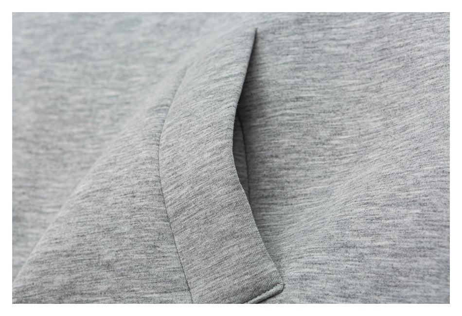 Close-up of a gray fabric seam and folded garment panel.