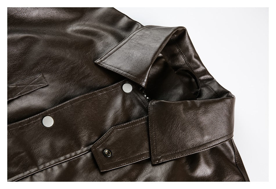 Close-up of a dark brown jacket collar, lapel, and silver snap fasteners.