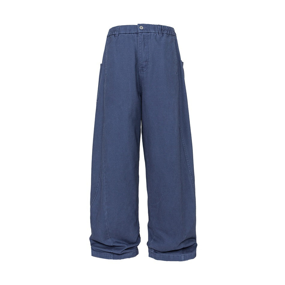 Front view of blue wide-leg pants with a button waist, elasticized sides, and large side pockets on a white background.