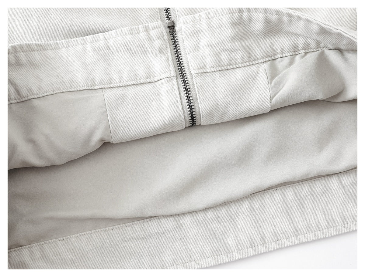 The off-white jacket is partly opened to show its smooth light-colored lining and front zipper.