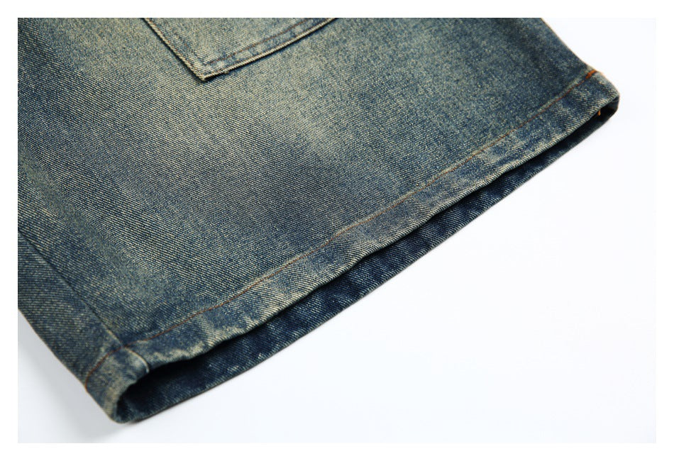 Close-up of the faded blue denim shorts’ stitched hem and lower edge.