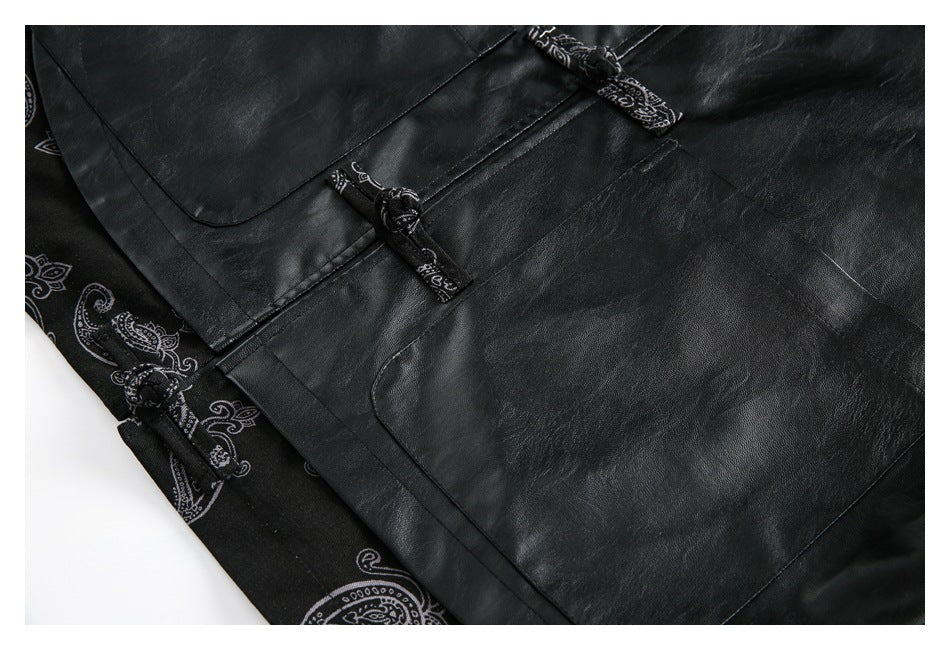Close-up of a black jacket with knotted closures, a large patch pocket, and paisley-print trim.