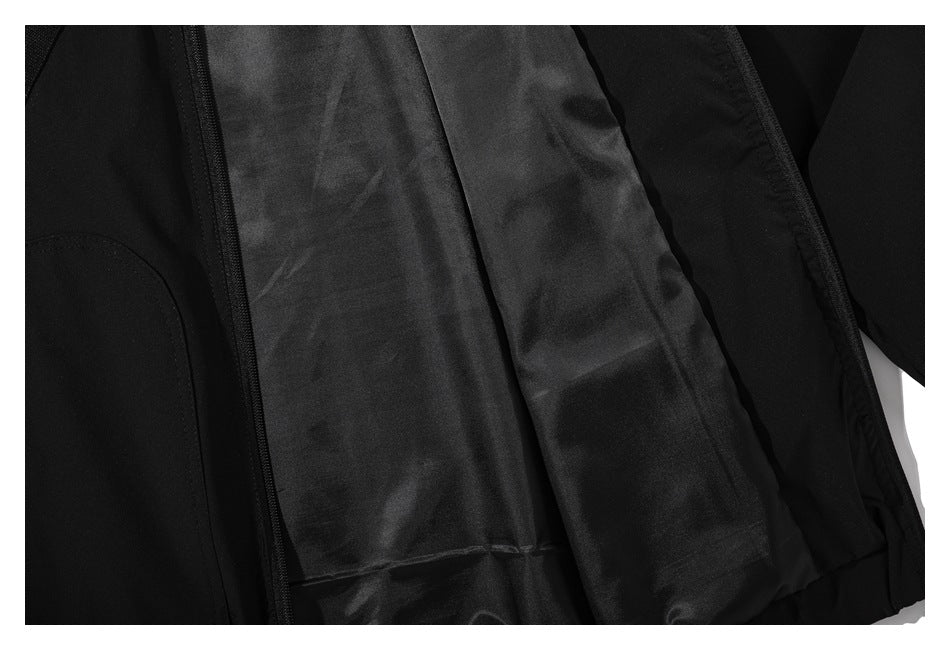 Close-up of a black jacket's interior lining and seam.
