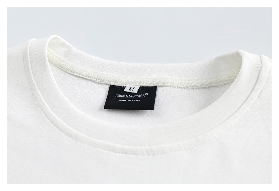 Close-up of a white sweatshirt's crewneck collar, stitching, and sewn-in size and brand label.